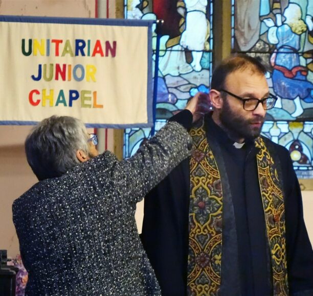 Melda helps dress Rev. Rob (Yes it takes a village to raise a minister!!)